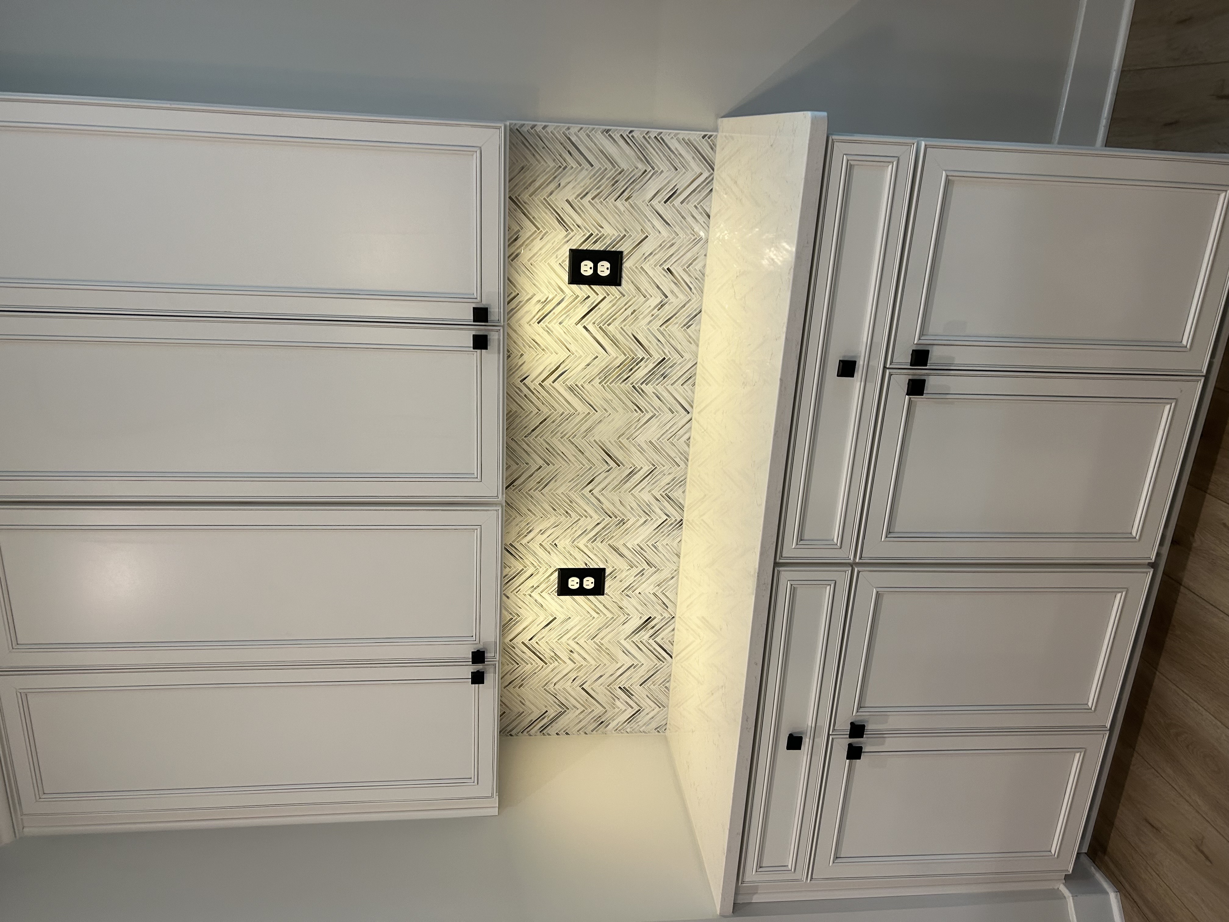 The left side of a kitchen with a white tile backsplash