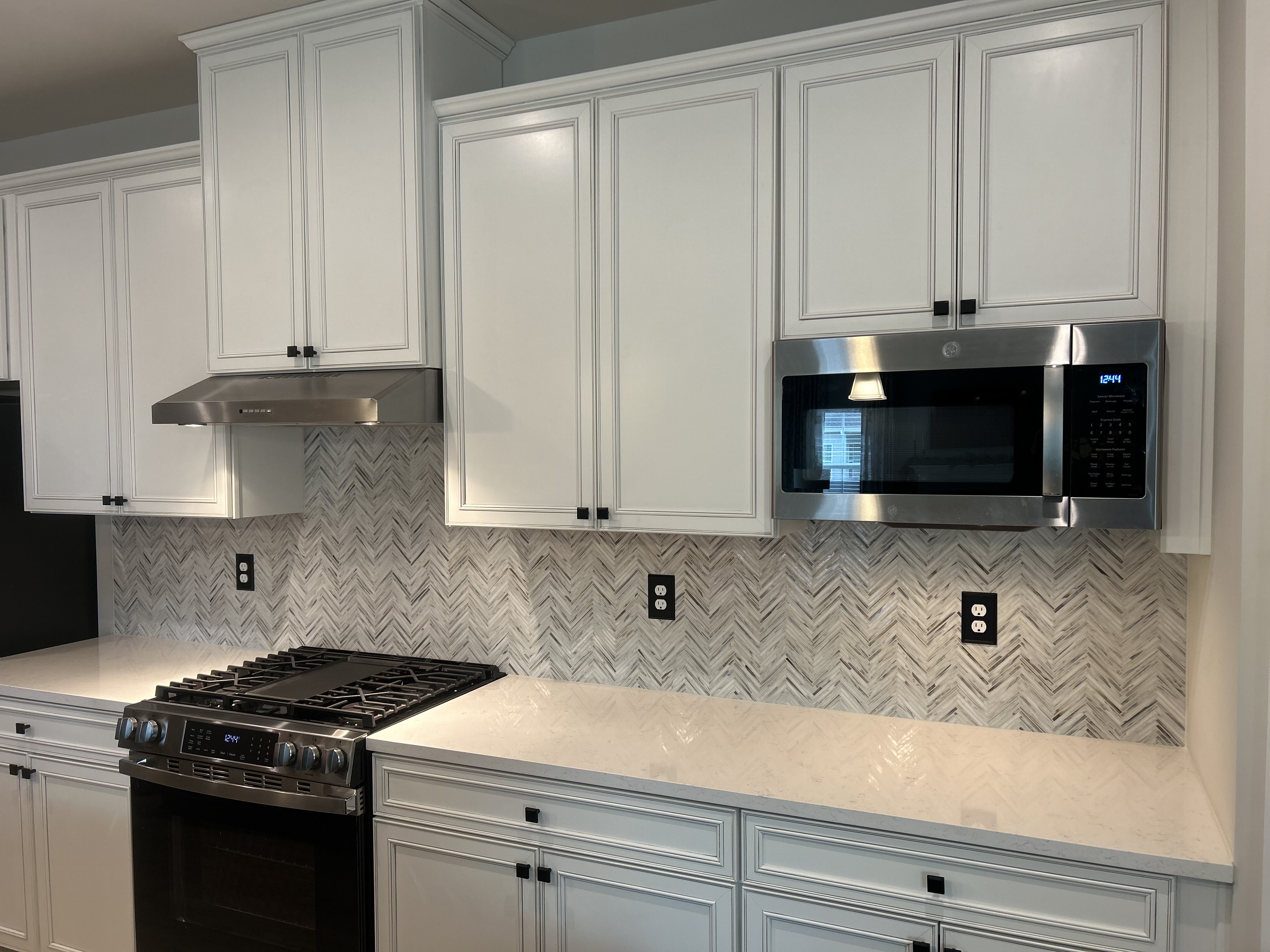 The right side of a kitchen with a white tile backsplash
